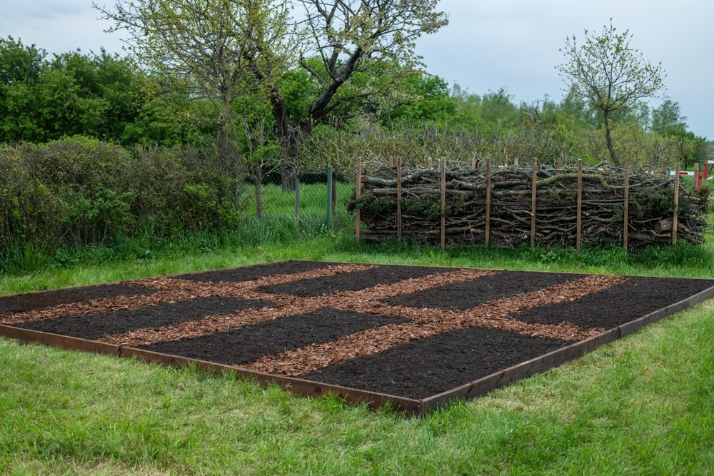 No-dig garden beds finished with dark compost and wood-chip paths