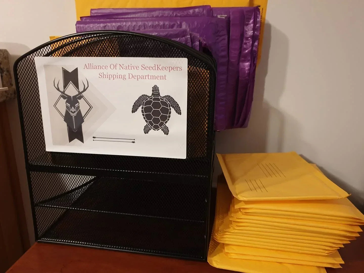 Alliance of Native Seedkeepers shipping department with padded mailers ready for seed orders