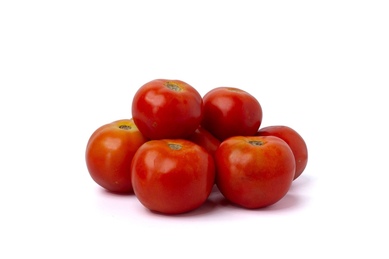 A group of round red tomatoes isolated on a white background