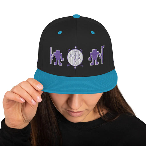 A woman wearing a black Alliance of Native Seedkeepers Merchandise Snapback Hat.