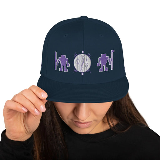 A woman wearing an Alliance of Native Seedkeepers Merchandise Snapback Hat.