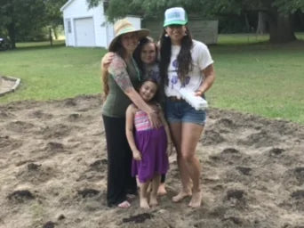 Beth Roach Cain with enrolled Chickahominy citizen Ashley Senegal in Ashley's home garden on traditional Chickahominy land