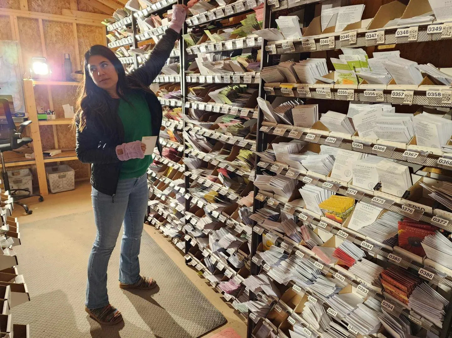 Beth counting seed into packets inside the crowded North Carolina seed shed