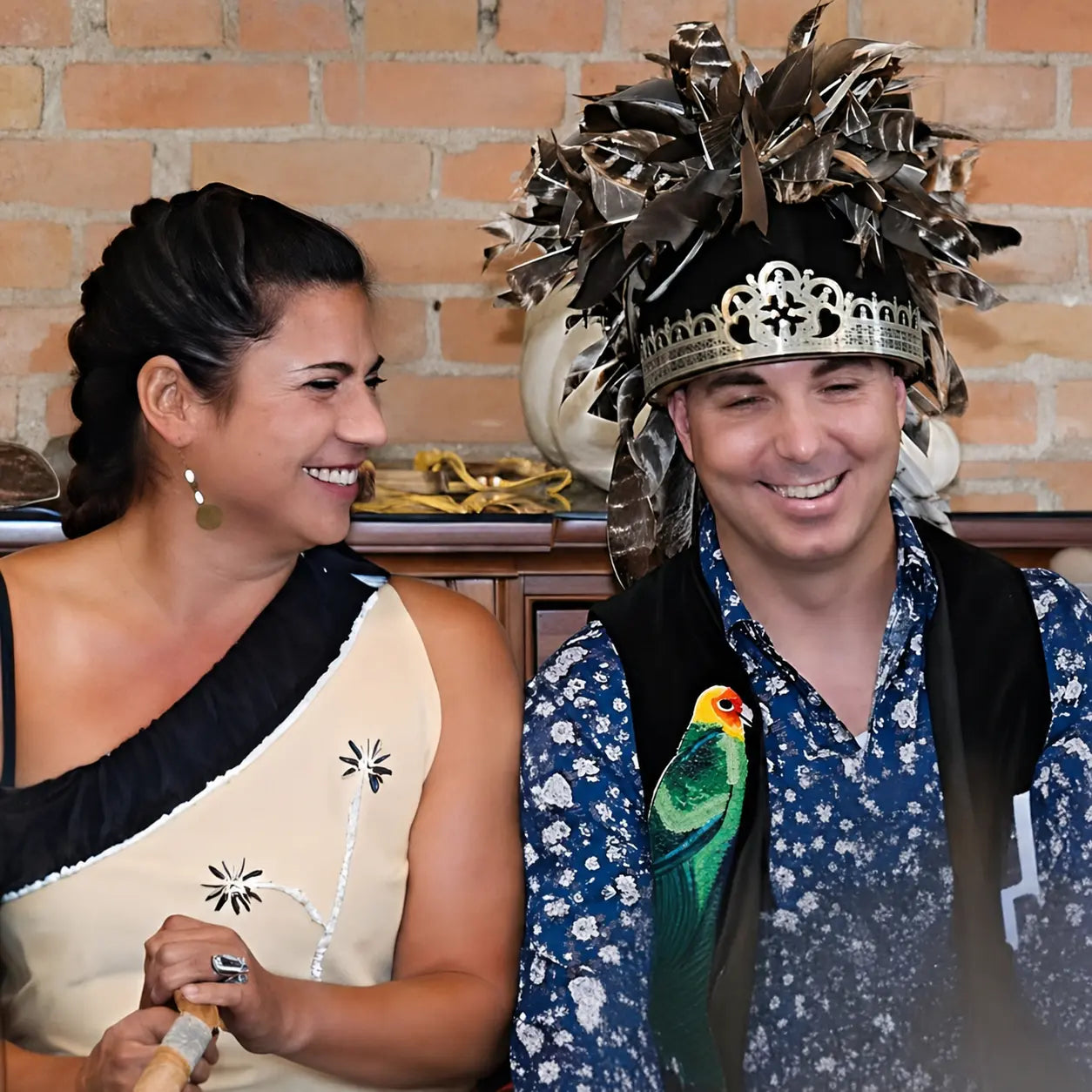Frank and Elizabeth Cain laughing together while wearing traditional regalia