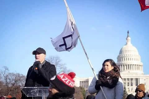 Frank J. Cain speaking in front of the White House in 2016 with Beth Roach Cain beside him