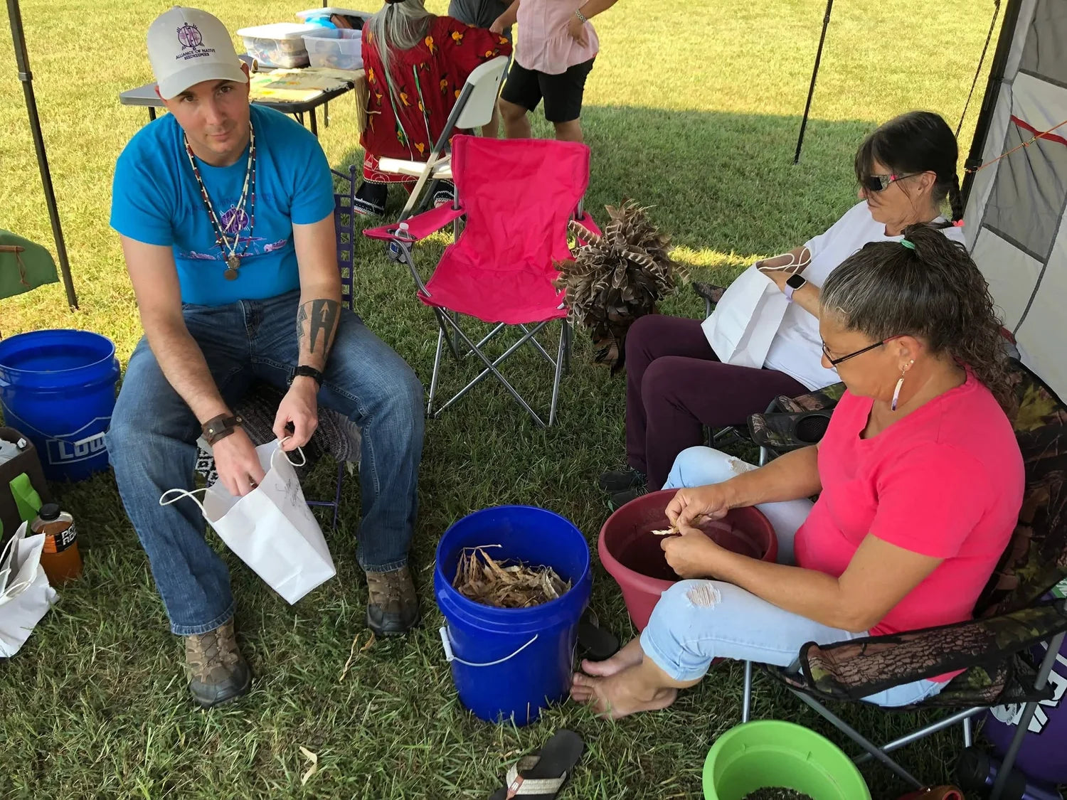 Frank Cain with his mother and aunt seeding okra at the 2019 Nottoway pow-wow
