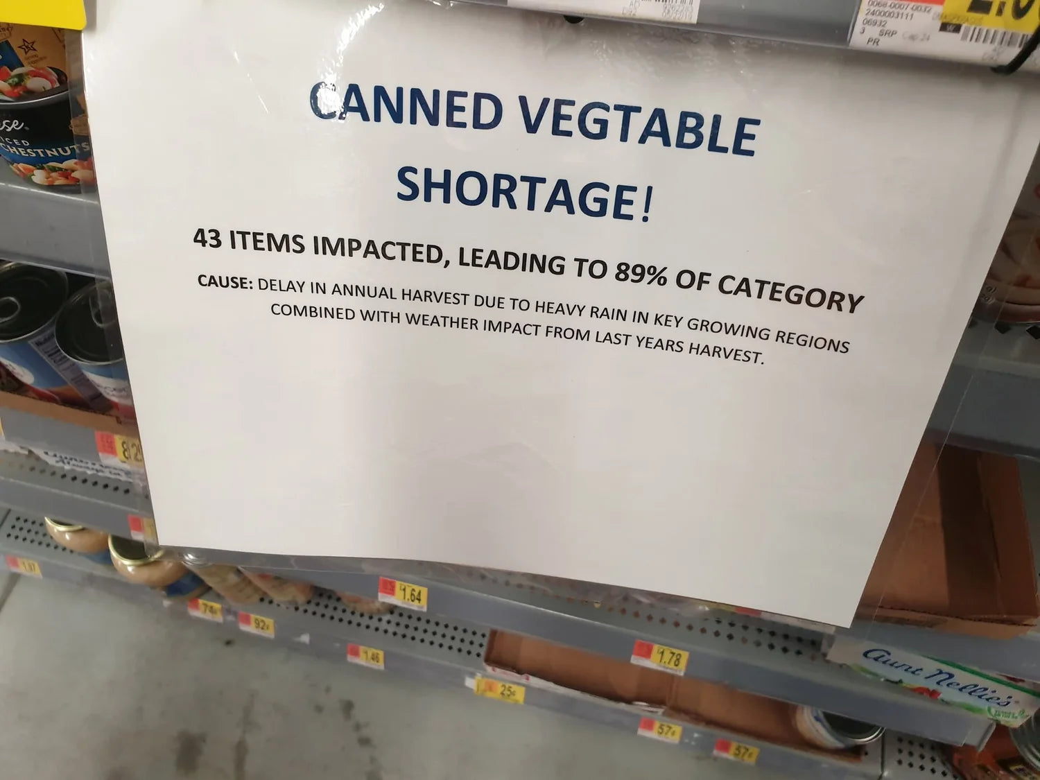 Richmond grocery store notice warning of a canned vegetable shortage caused by delayed harvest and heavy rain